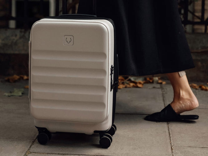 a person standing next to a suitcase