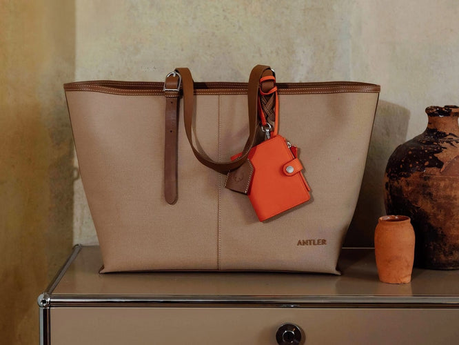 a tan purse with a tag on it