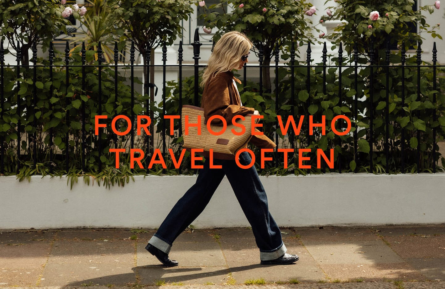 a woman walking on a sidewalk with a bag