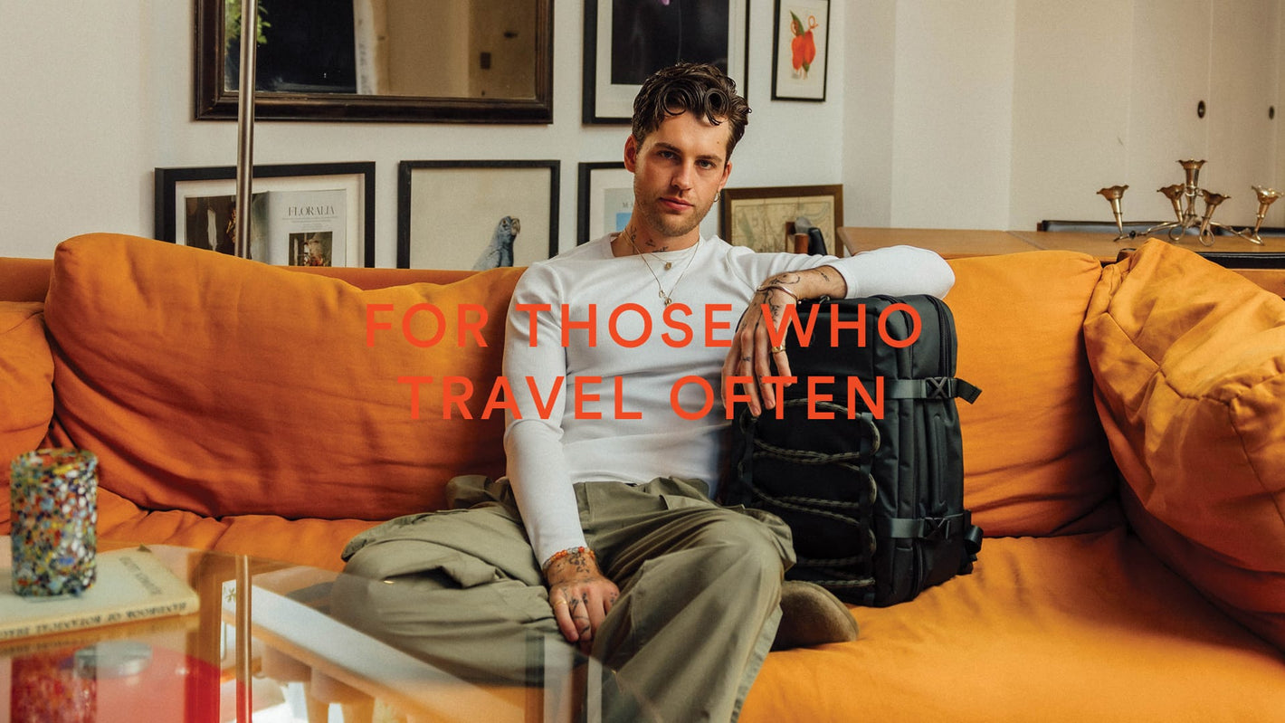 a man sitting on a couch with a backpack