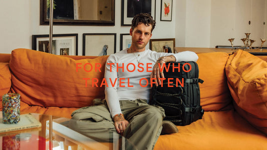 a man sitting on a couch with a backpack