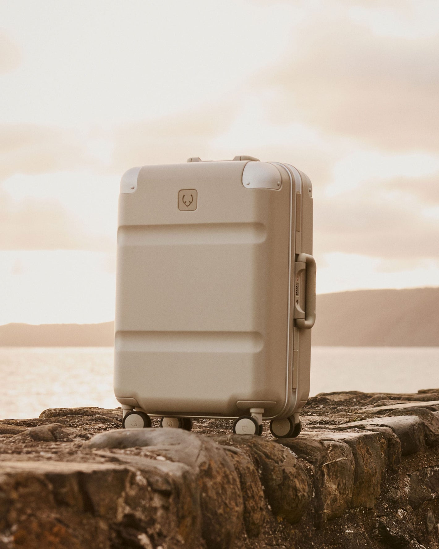 a suitcase on a rock wall