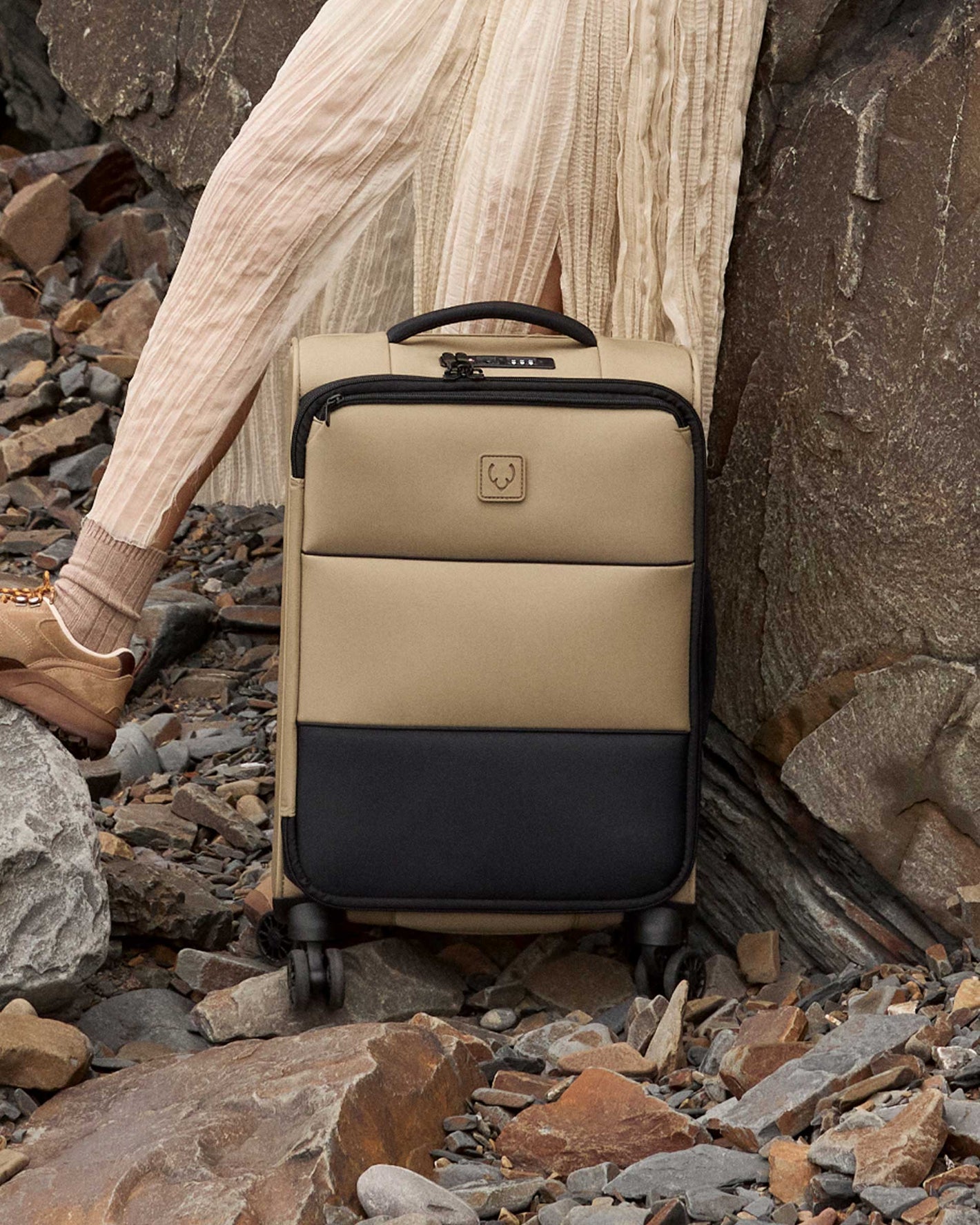 a person's legs and a suitcase