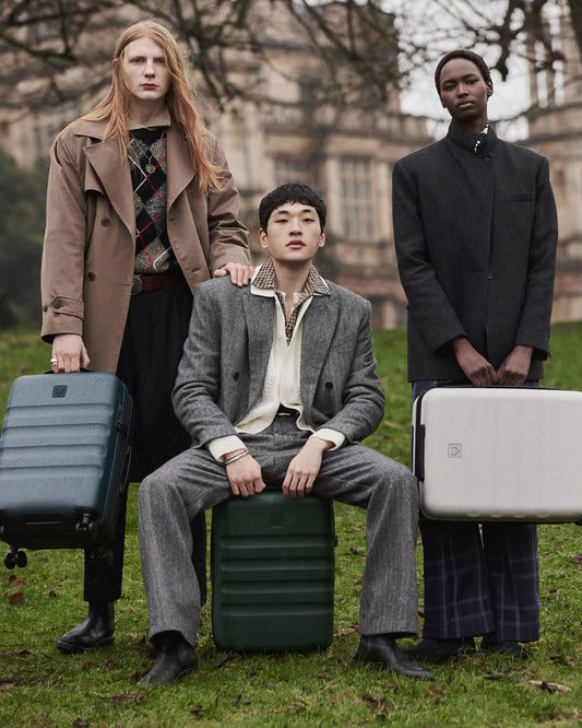 a group of people sitting on luggage