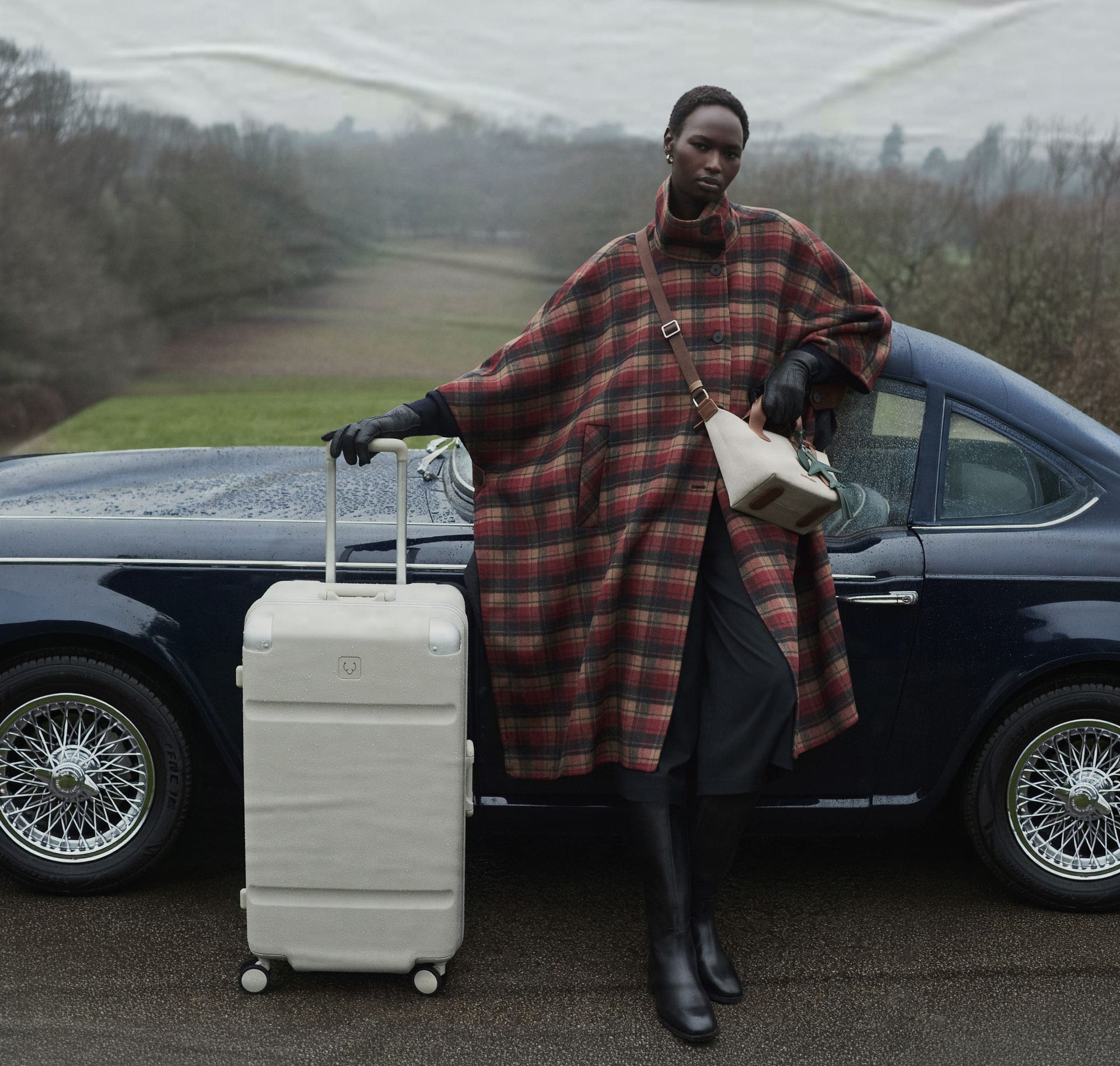 a woman standing next to a car with luggage