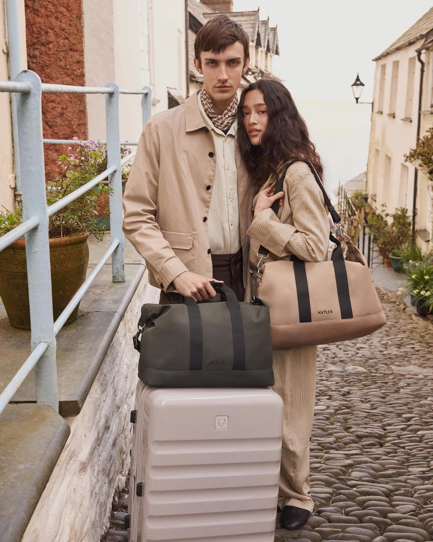 a man and woman standing next to luggage