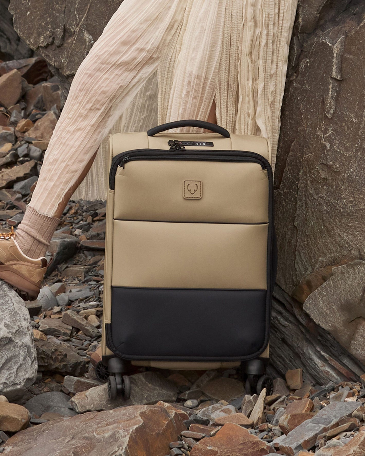 a person standing next to a suitcase