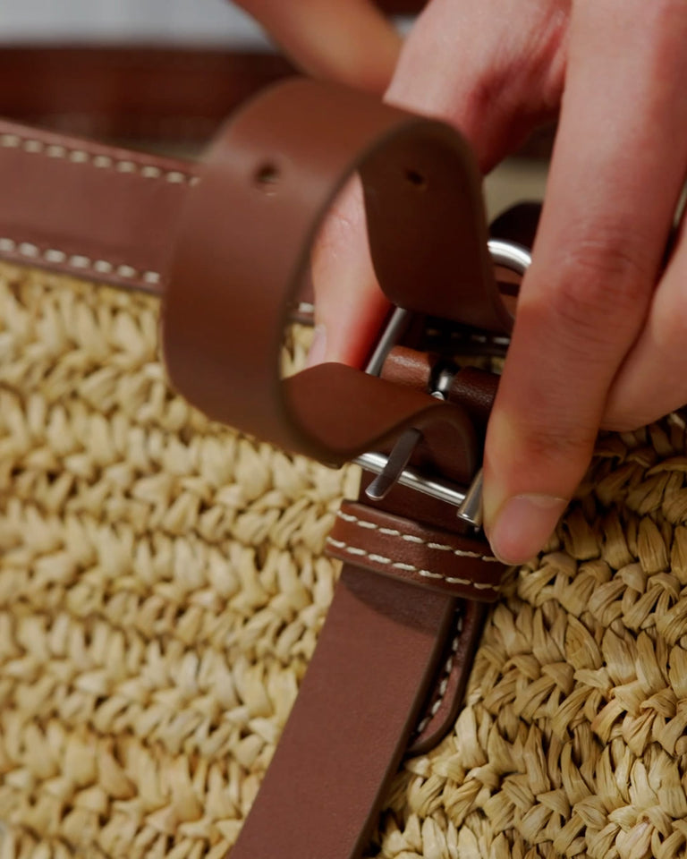 a hand holding a belt