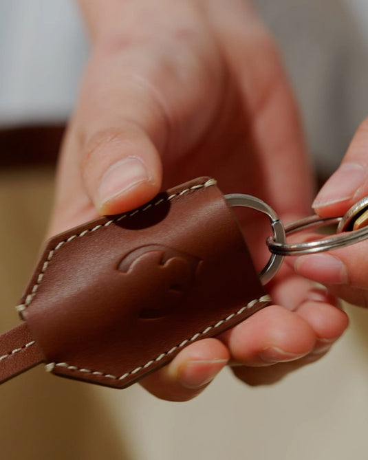 a person holding a key chain