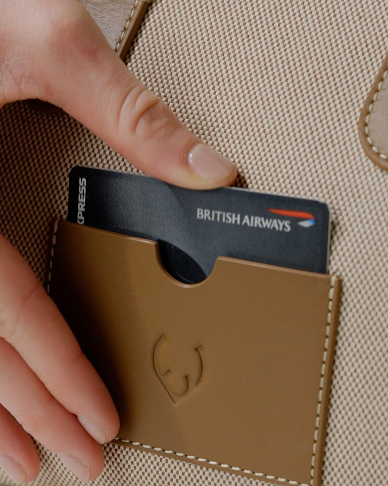 a hand holding a card in a wallet