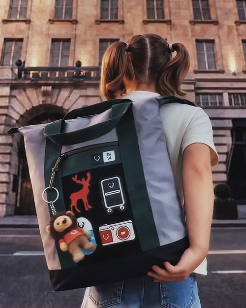 a girl holding a backpack