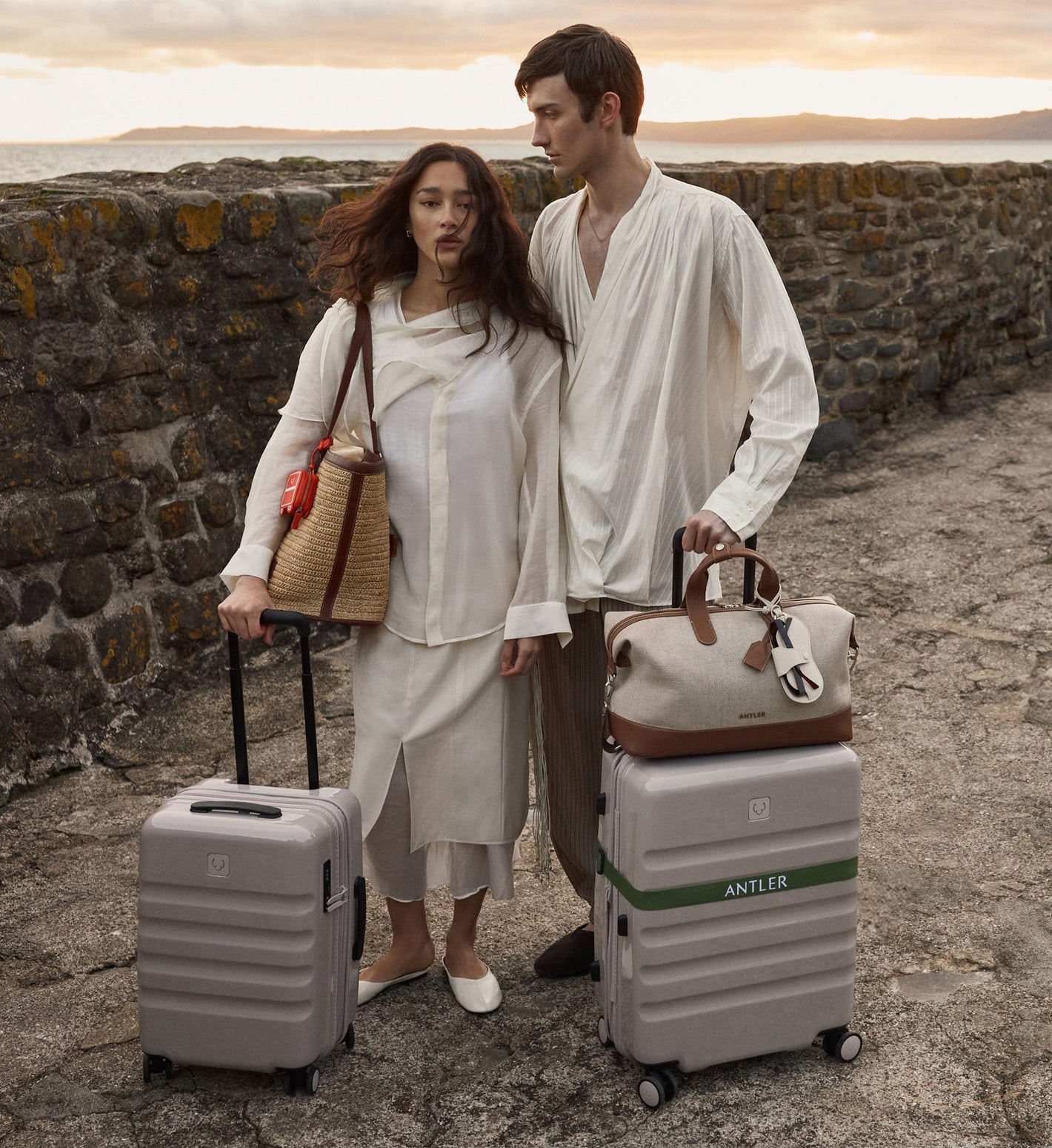a man and woman standing next to luggage
