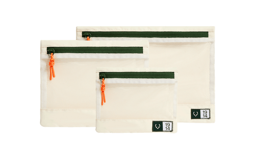a group of white bags with green zippers