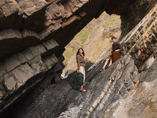 a man and woman standing in a cave