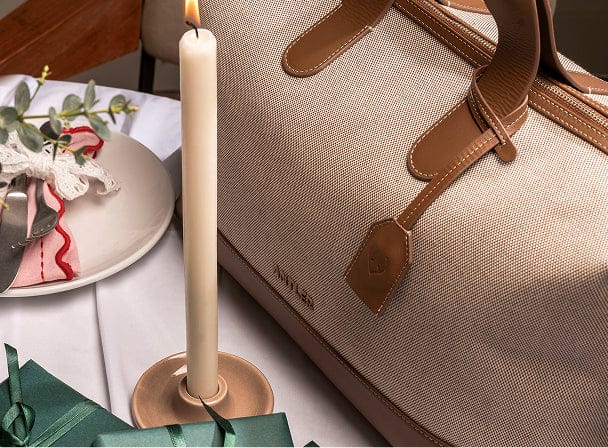 a candle next to a bag