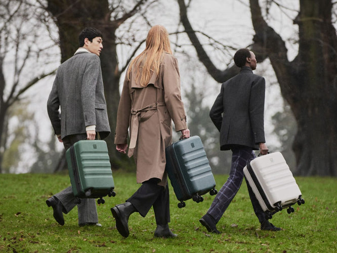 a group of people walking with luggage