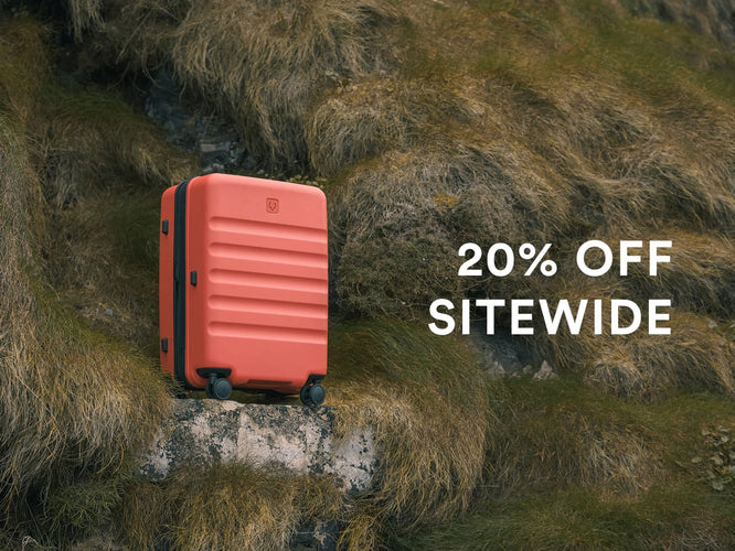 a red suitcase on a rock