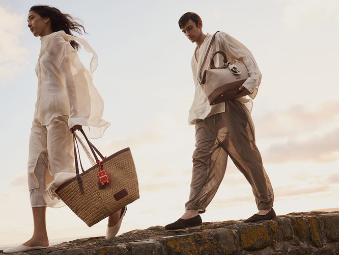 a man and woman walking on a stone wall