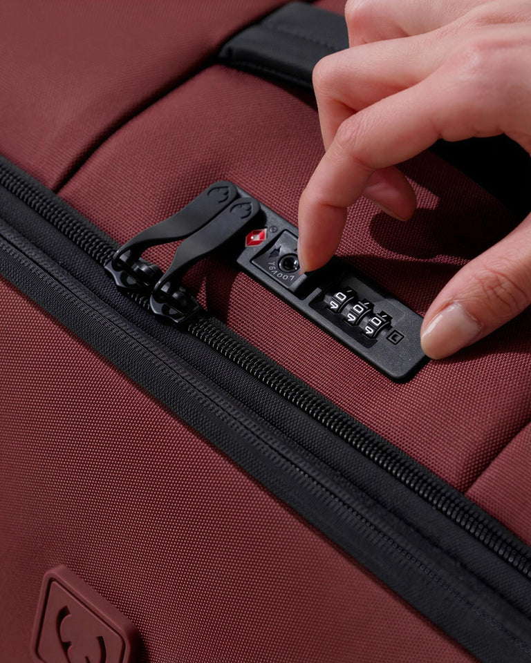 a hand opening a suitcase