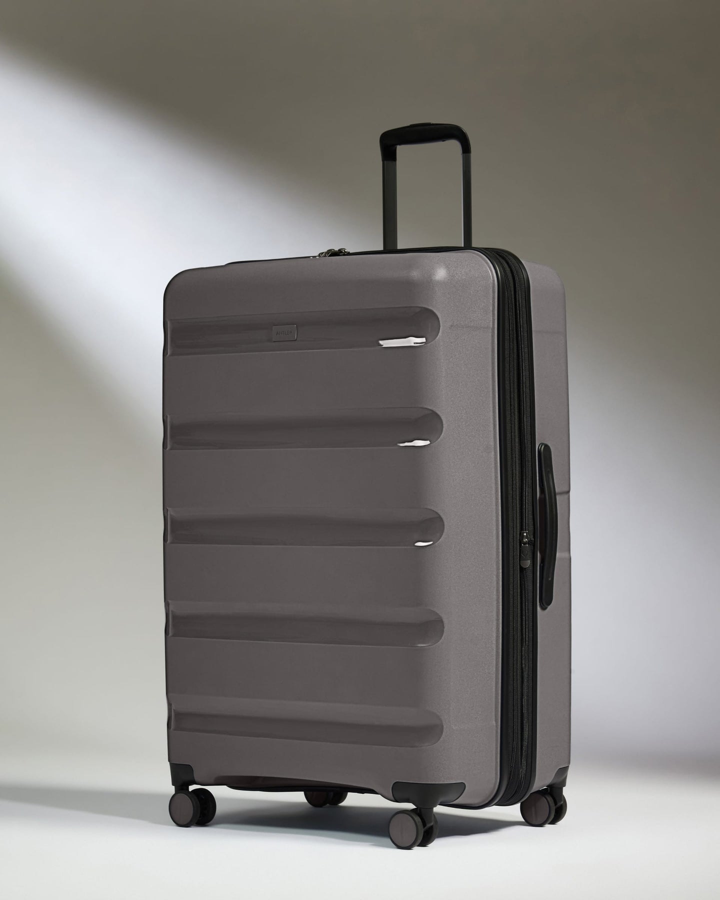 Antler Luggage -  Expandable Large Suitcase in Gloss Gull Grey - Logo Stripe - Expanding Rollercase | Large 4W Expandable Large Suitcase in Gloss Gull Grey - Logo Stripe