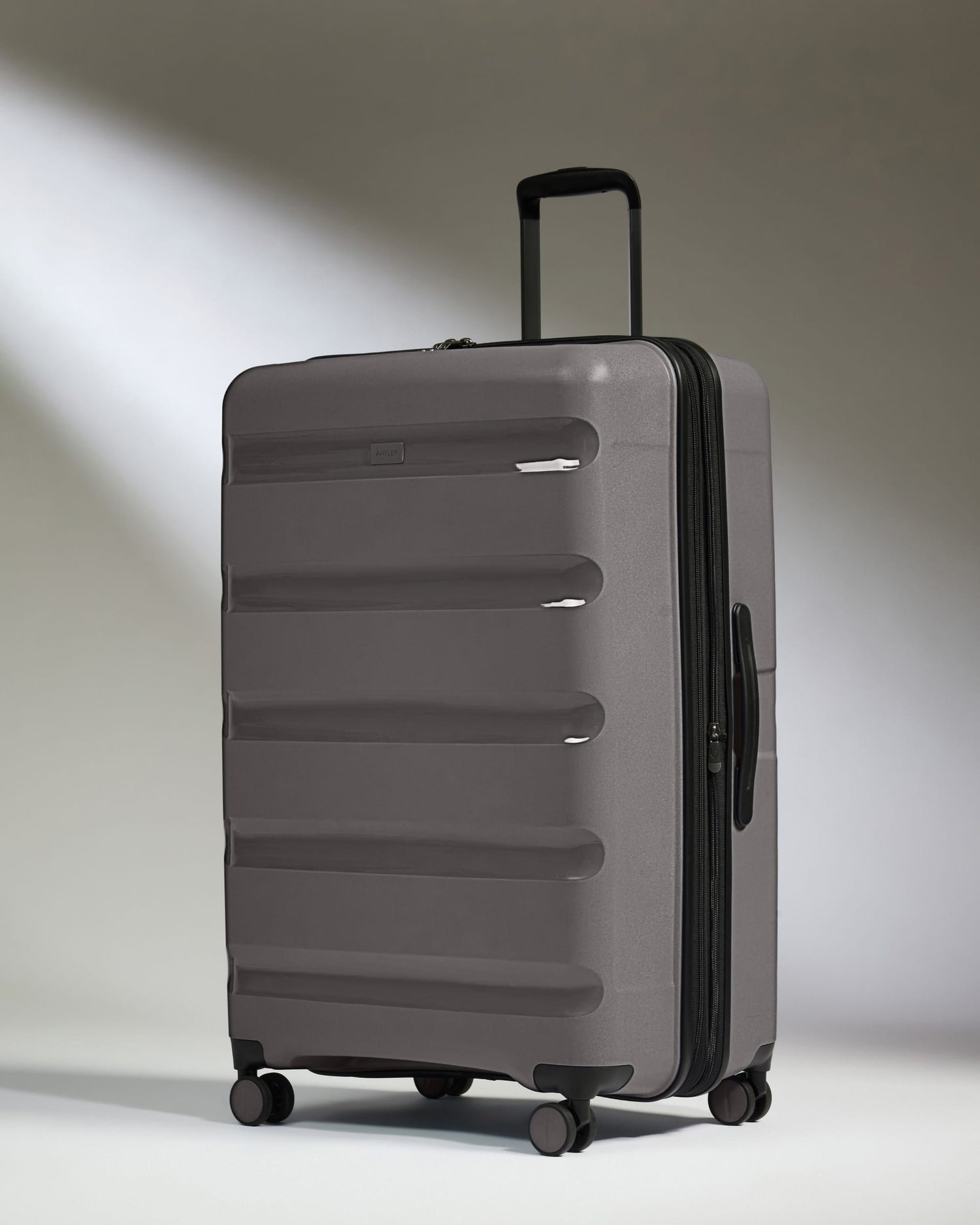 Antler Luggage -  Expandable Large Suitcase in Gloss Gull Grey - Logo Stripe - Expanding Rollercase | Large 4W Expandable Large Suitcase in Gloss Gull Grey - Logo Stripe