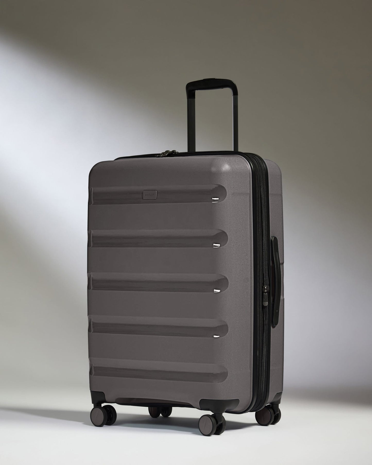 Antler Luggage -  Expandable Medium Suitcase in Gloss Gull Grey - Logo Stripe - Expanding Rollercase | Medium 4W Expandable Medium Suitcase in Gloss Gull Grey - Logo Stripe