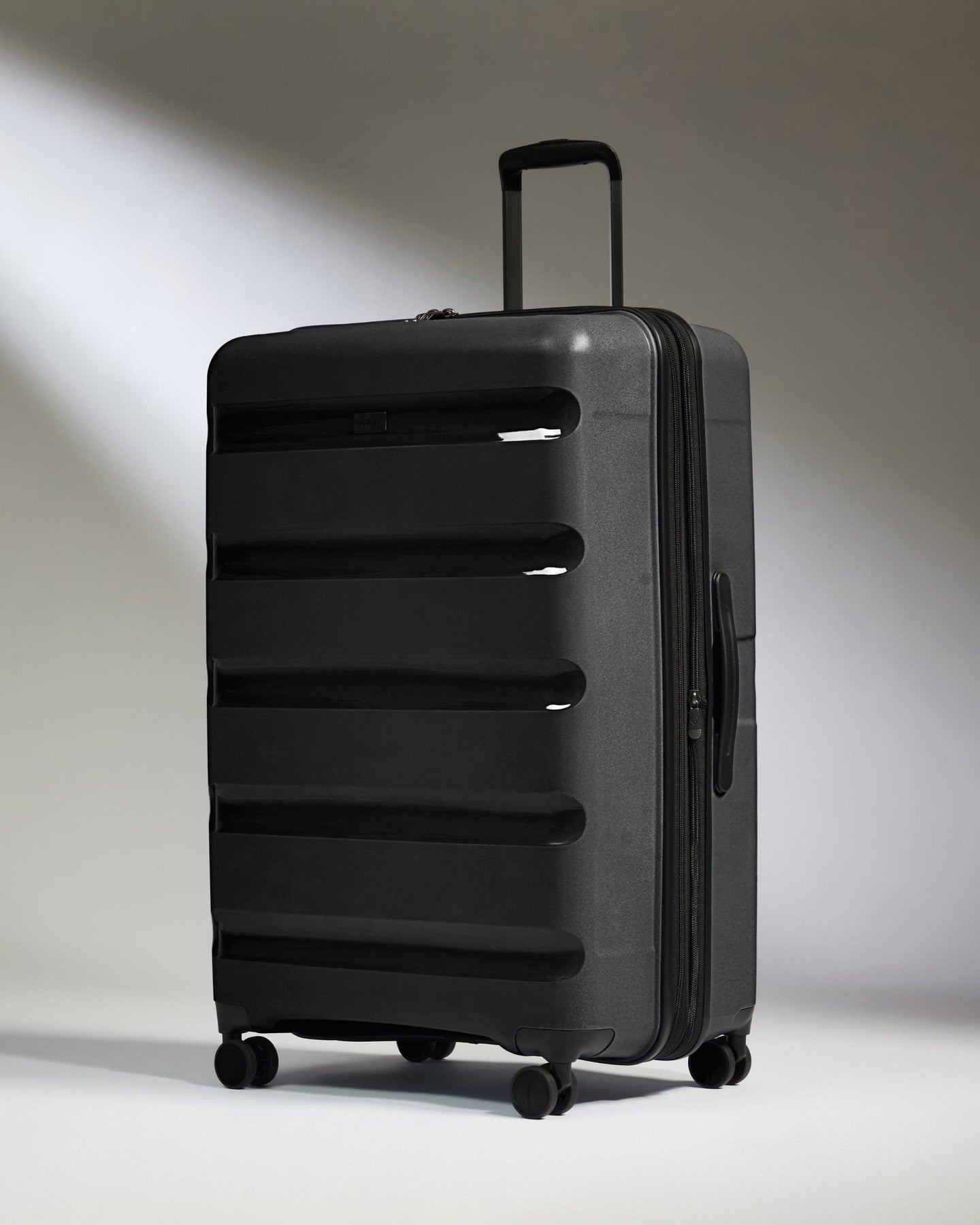 Antler Luggage -  Large Suitcase in Black - Logo Stripe - Hard Suitcase - Large Large Suitcase Black - Logo Stripe | Lightweight Hard Shell Luggage