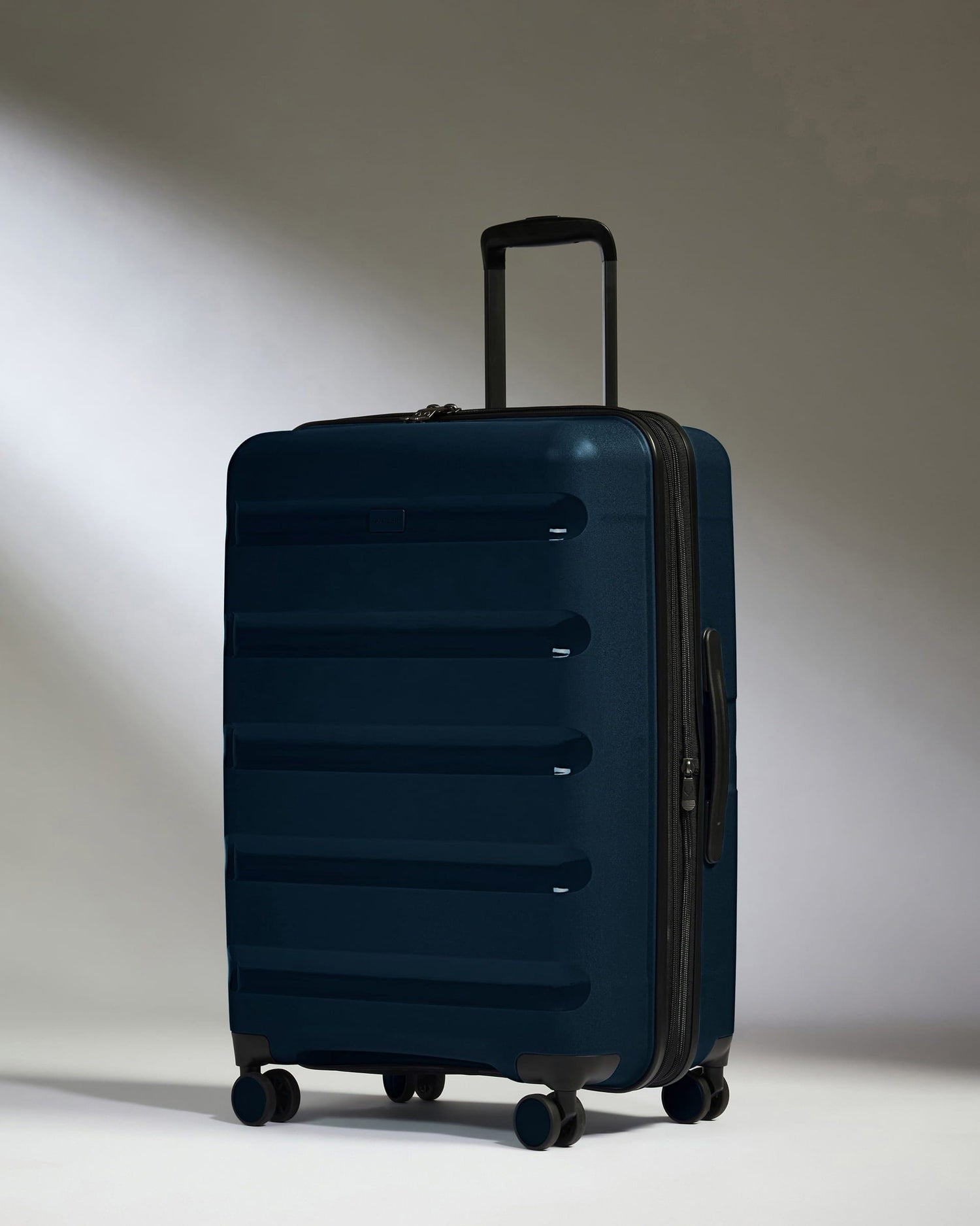 Antler Luggage -  Medium Suitcase in Midnight Blue - Logo Stripe - Hard Suitcase - Medium Medium Suitcase Midnight Blue - Logo Stripe | Lightweight Hard Shell Luggage