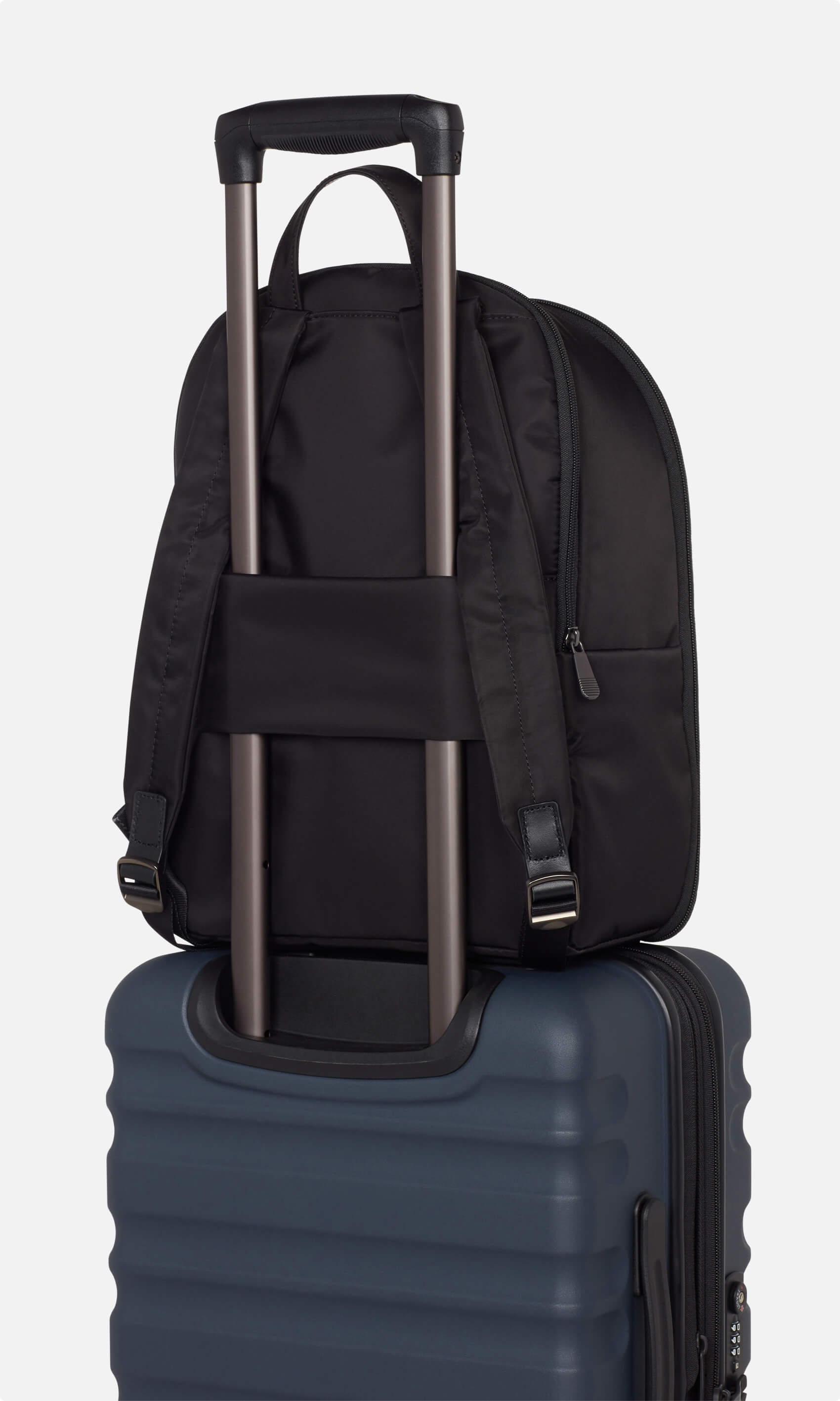 Backpacks that fit over luggage handle clearance